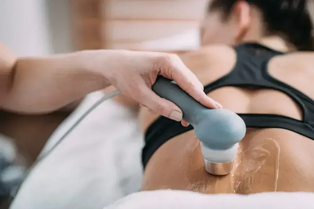 Ultrasound therapy device on a person's back during treatment.